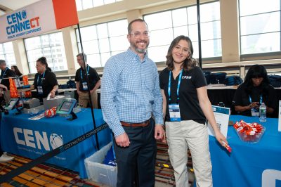 Deanna and Ryan at a sponsor booth 