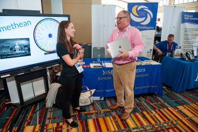2 people talking at y&s technologies sponsor booth