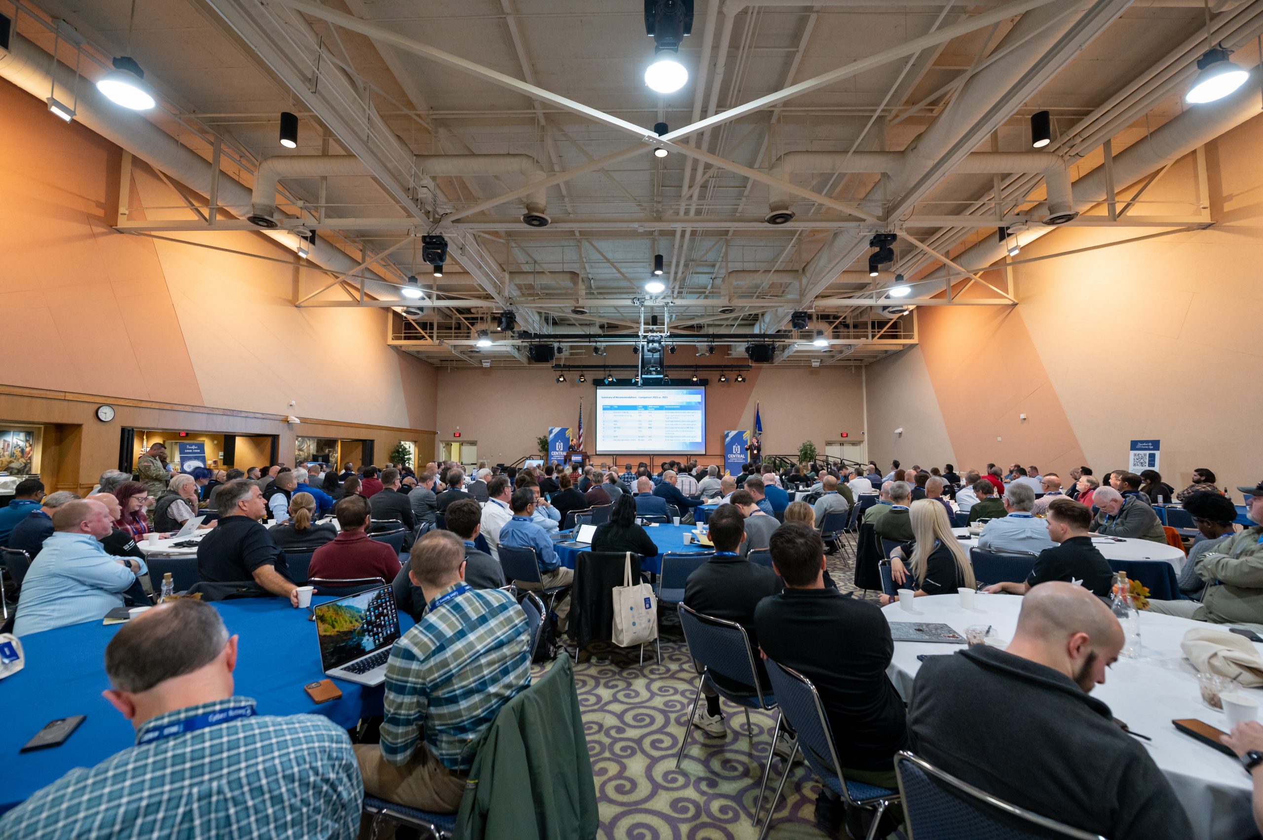 Attendees sitting at their tables in the main conference room