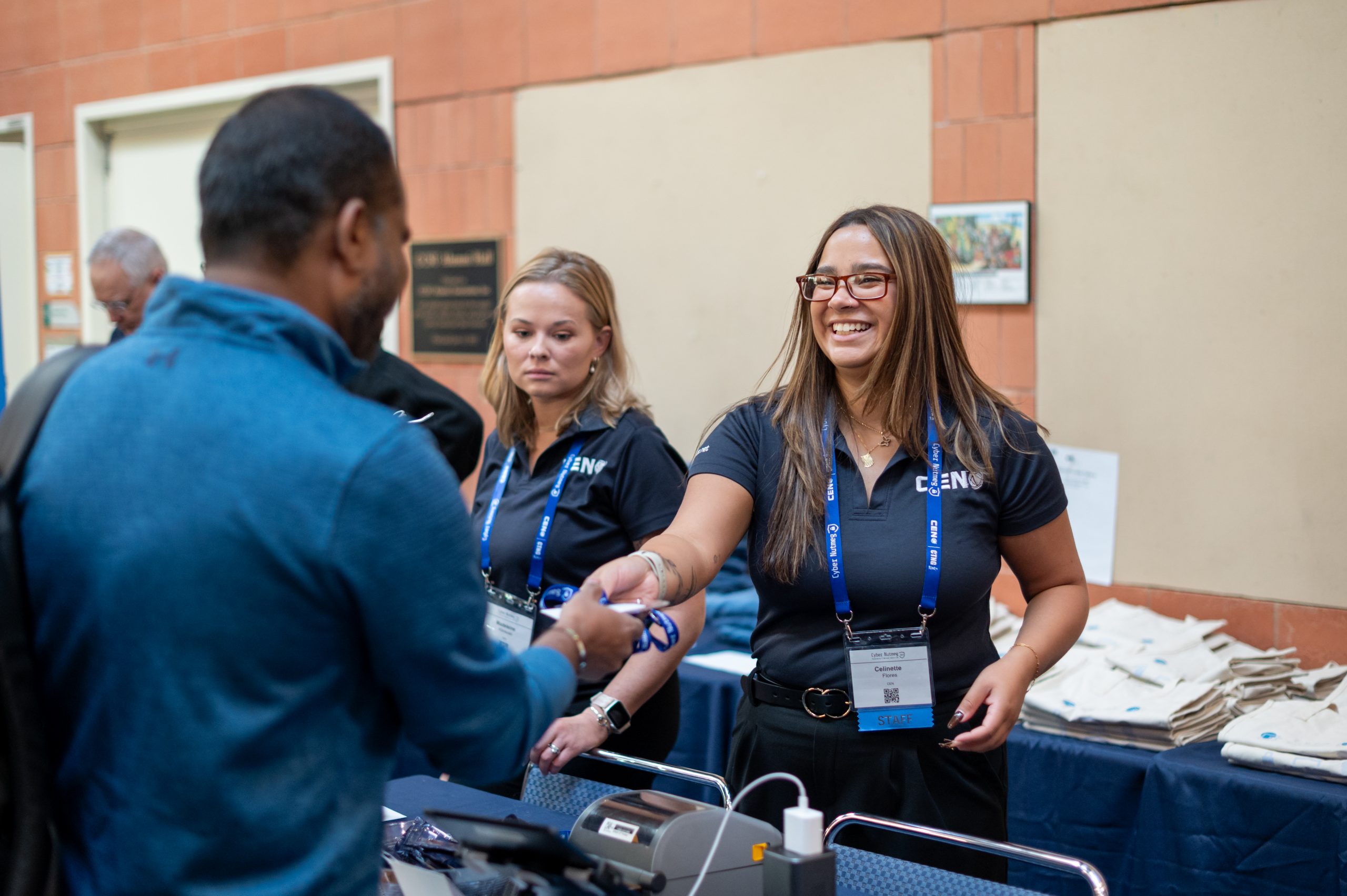 CEN team member passing an attendee their lanyard