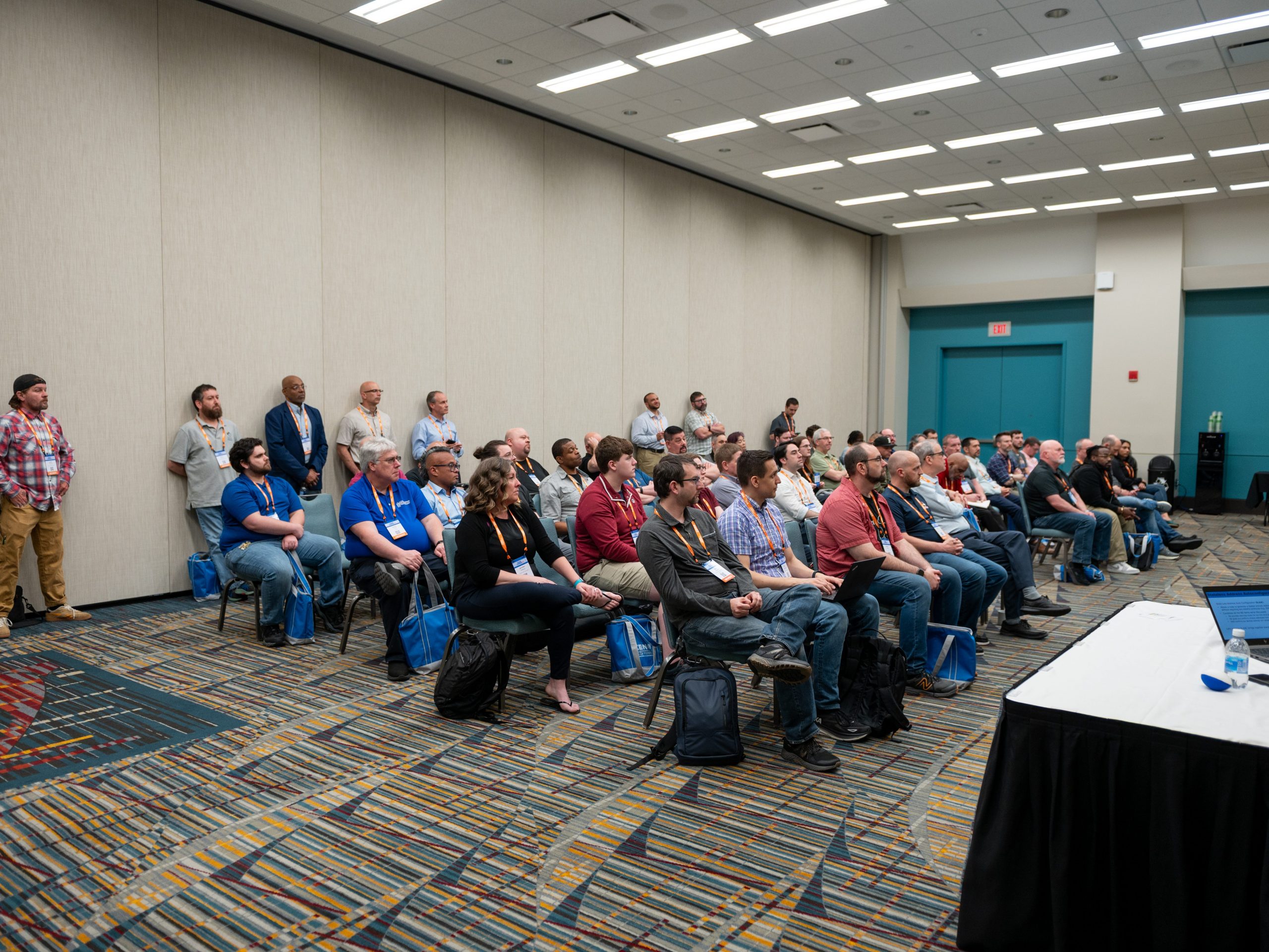 attendees sitting in a conference room listening to a session being taught