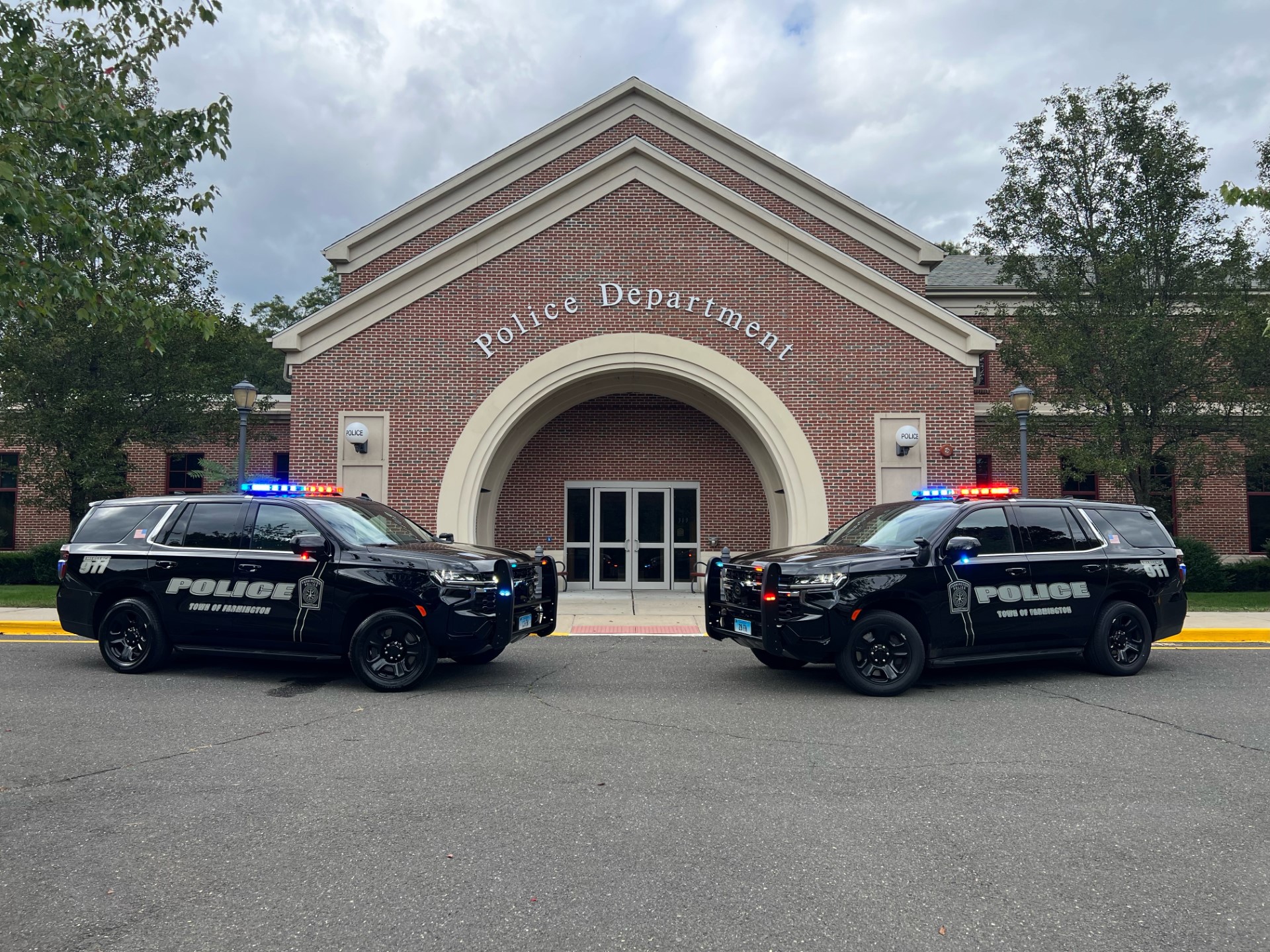 Police department building with two police cars infront